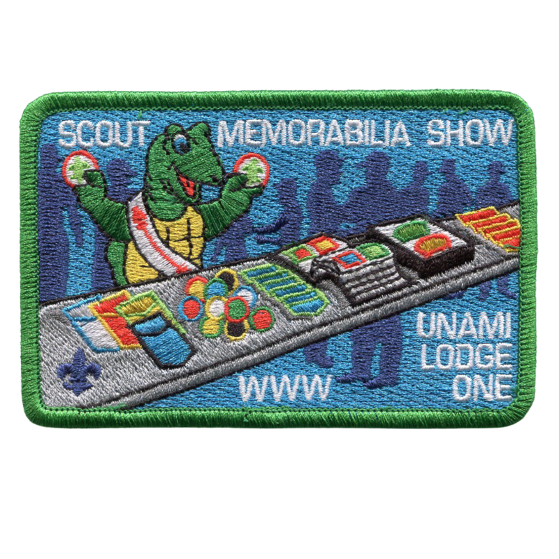 Image of the Scout Memorabilia Show Patch which features Fred the turtle looking at patches on a table